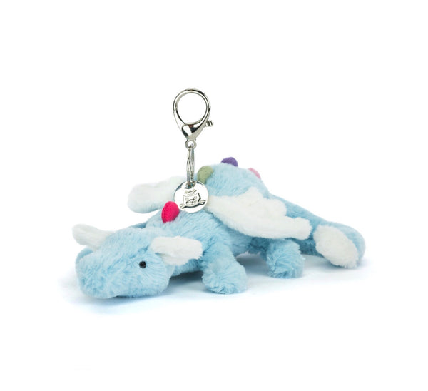 Plush blue dinosaur keychain with a tag on a white background