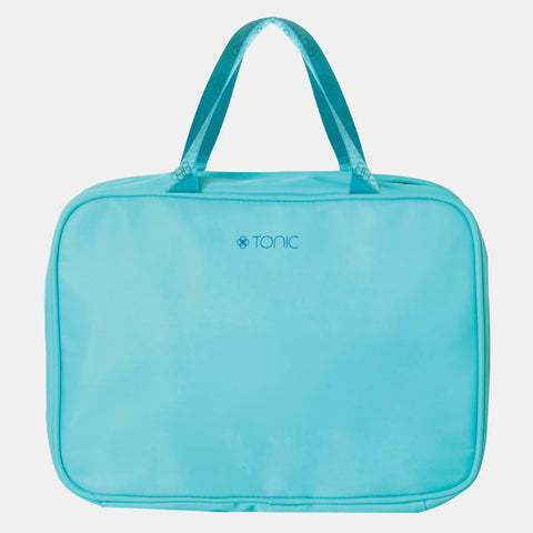 Turquoise toiletry bag with 'Tonic' branding on a light gray background