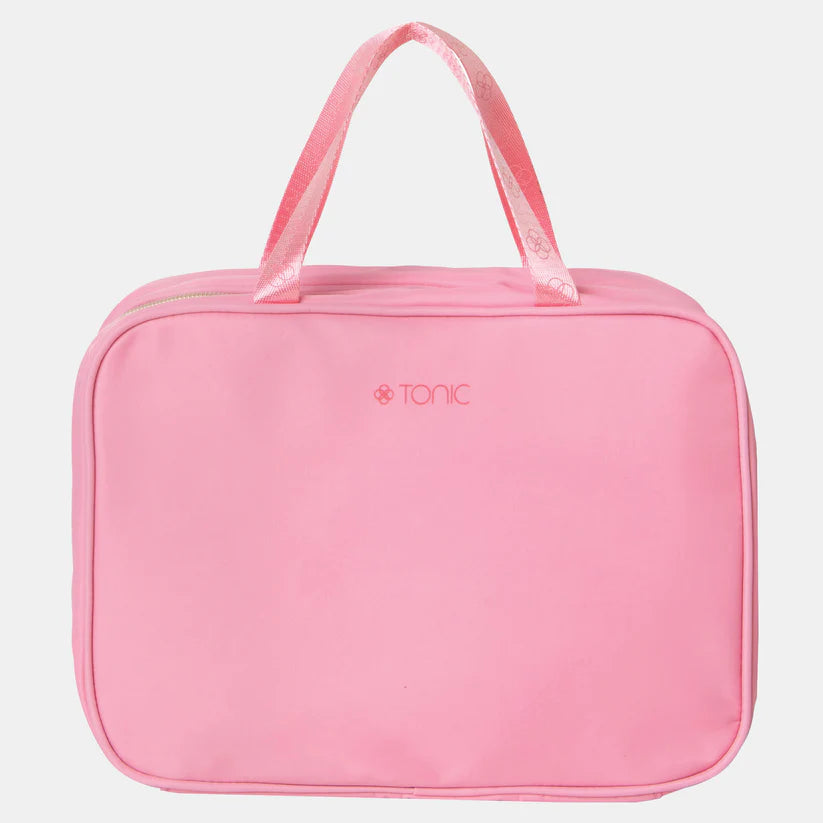 Pink toiletry bag with 'Tonic' branding on a light gray background