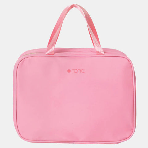 Pink toiletry bag with 'Tonic' branding on a light gray background